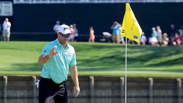 Ryan Fox acknowledges the crowd after picking his ball out of the hole after a hole in one at the 17th hole during the first round of the 2024 Players Championship on the Stadium Course at TPC Sawgrass in Ponte Vedra Beach, Fla.